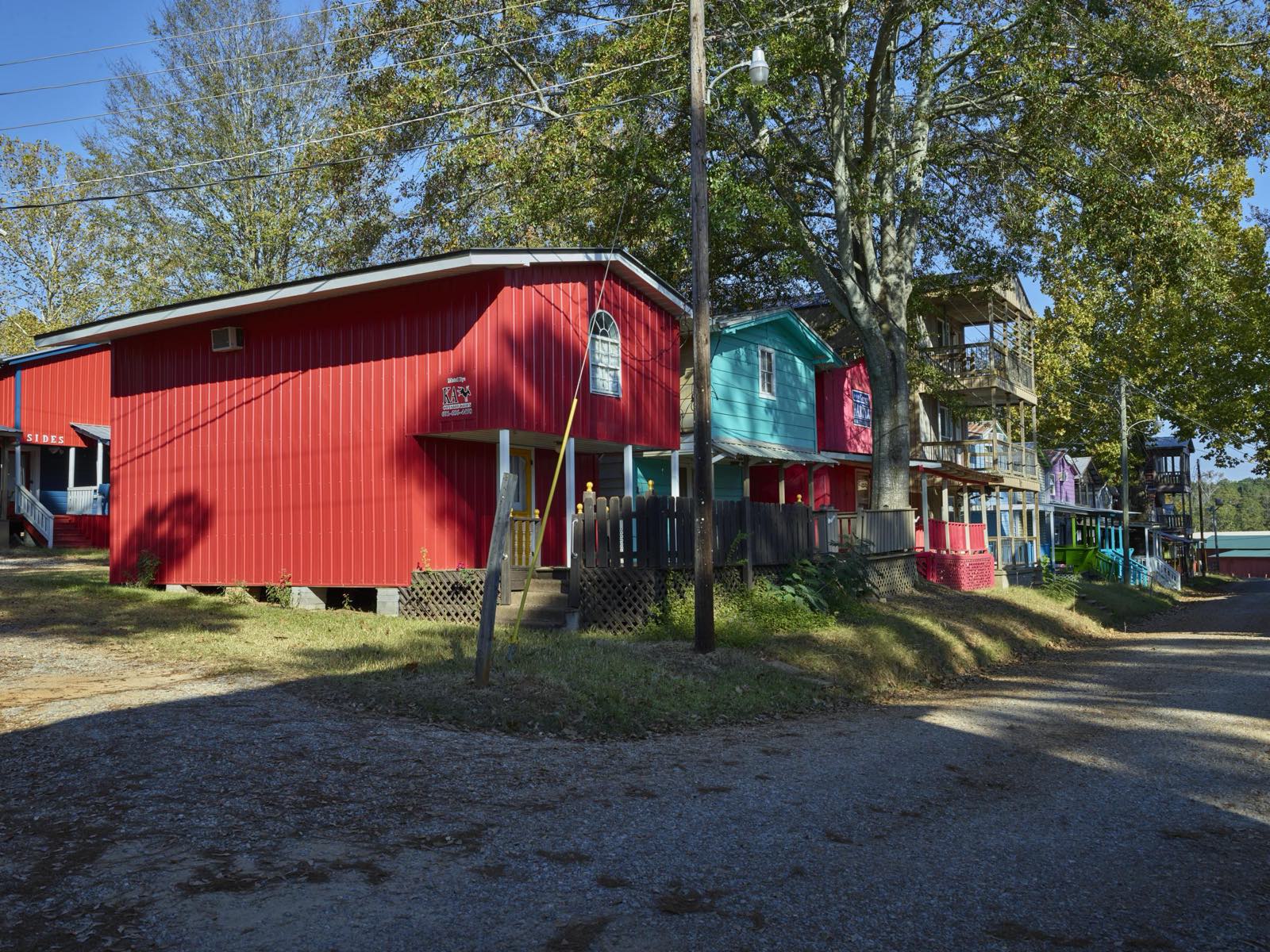 Brightly painted red, teal and pink cabins line a gravel lane at the Neshoba County Fair grounds near Philadelphia, Mississippi.